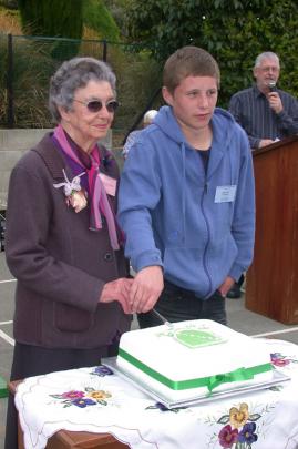 Cutting the cake are the oldest pupil, 97-year-old Bina Mulligan (nee Fallon) of Oamaru, and the...