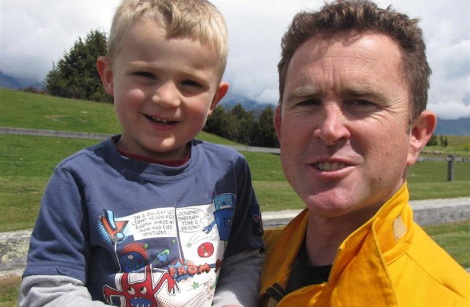 Saxon Cowan (4) with his  father  Jamie, Department of Conservation Wakatipu's rural fire officer.