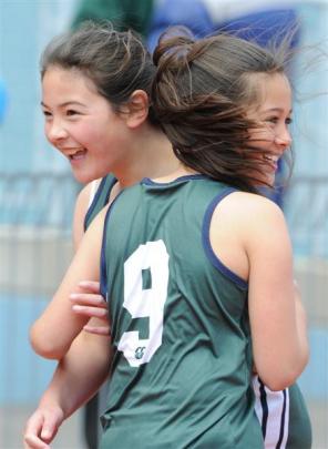 Columba College relay runner Maia Joseph (No 9) embraces team-mate Nikita Horne (both 10)