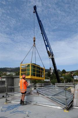 Alistair Newall, of Smartlift Cranes, watches over the removal of demolition waste, which is...