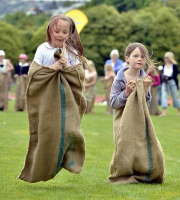 Kendall Garrett (5) (left) and Aria Monks (7) bounce their way to the line in the girls sack race.