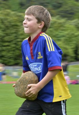 Tiane King (9) competes in the boys' Carry the Stones.