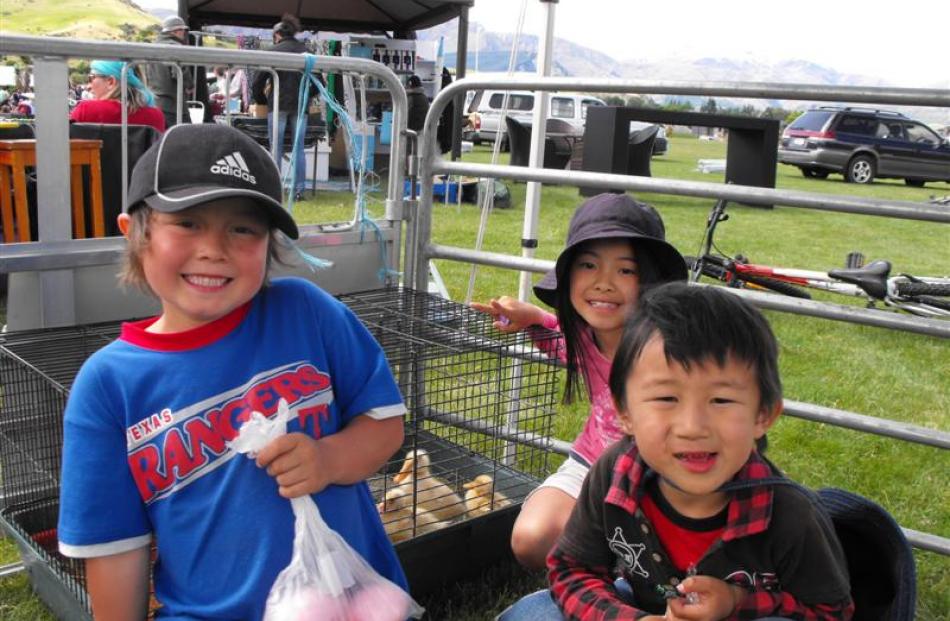 Sean Oberrgawa (8, left), Sho Kameyama (5, front) and Alissa Ibe (7) show interest in the ducklings.