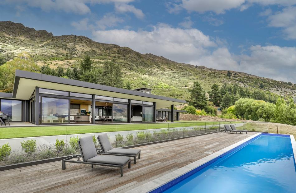 This property near Wanaka has a 20m lap pool which is heated via solar panels on the shed roof.