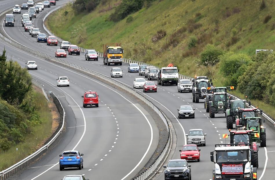 Farm vehicles slowly snake their way along the Southern Motorway from Mosgiel to Dunedin...