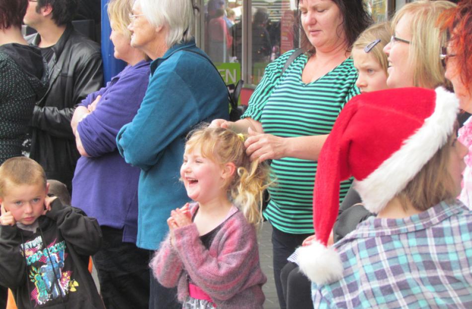 A child at the Oamaru Santa Parade waits eagerly for a glimpse of Santa.