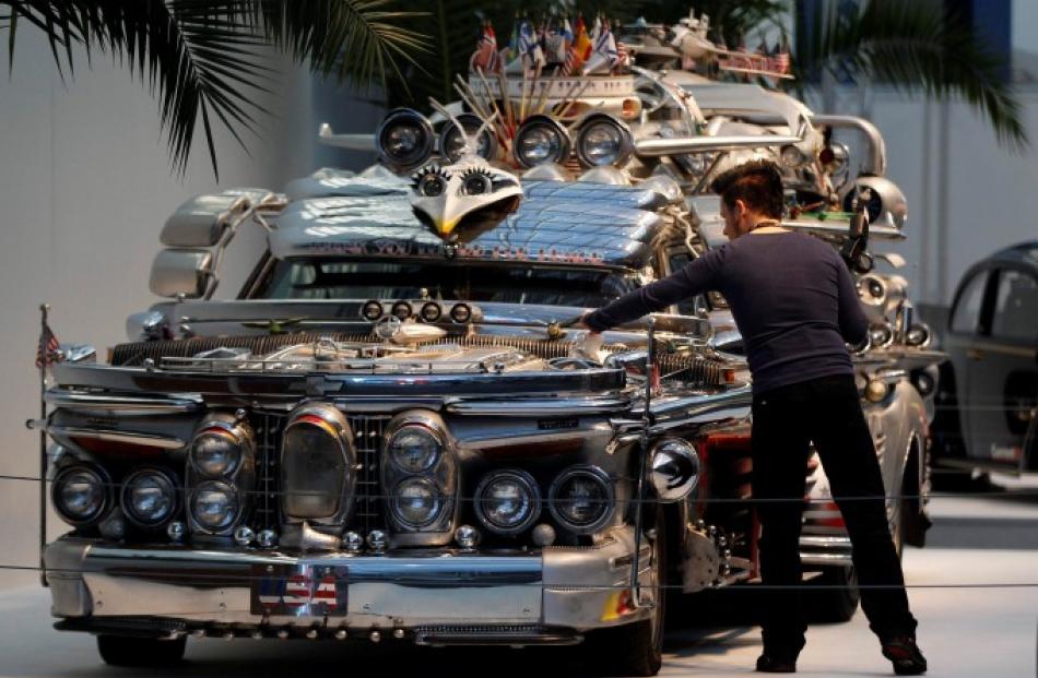 A visitor to the show looks at the 'Finnjet' car built by 70-year old Antti Rahko. REUTERS/Ina...