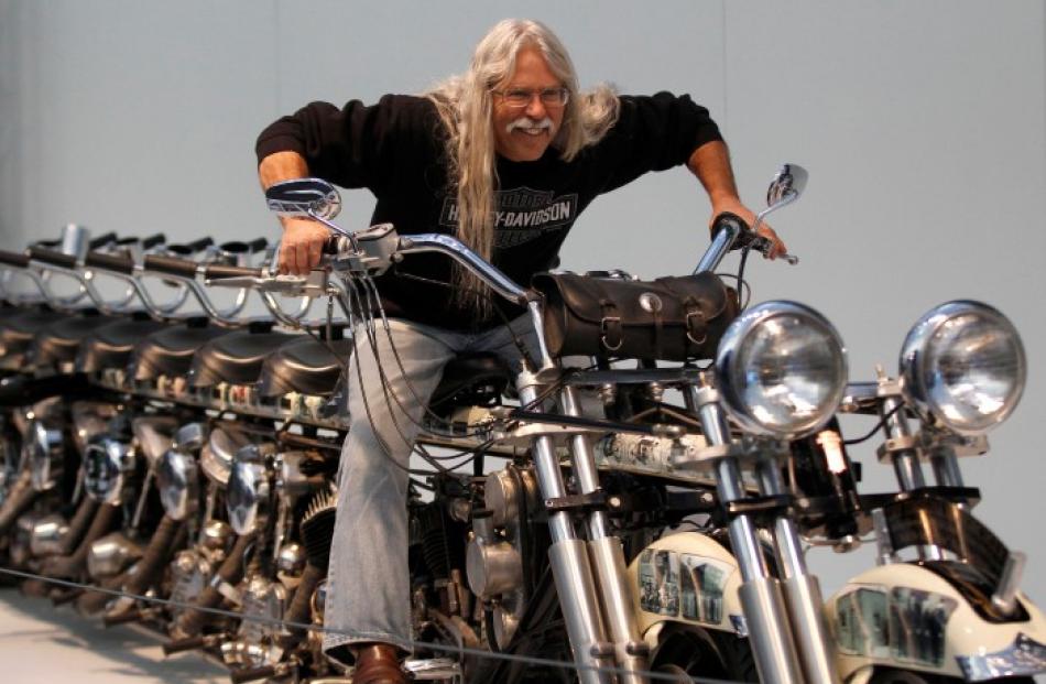 Steve 'Doc' Hopkins poses on his 10-seat Timeline Motorcycle during a press presentation before...