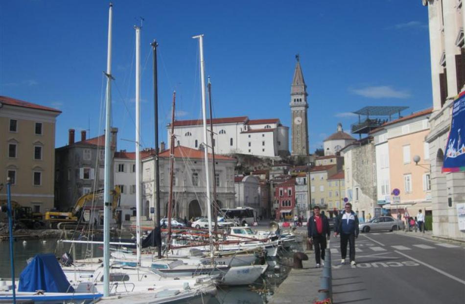 Stroll along Piran's coastline, past cafes and restaurants, to the Punta Madonna lighthouse.