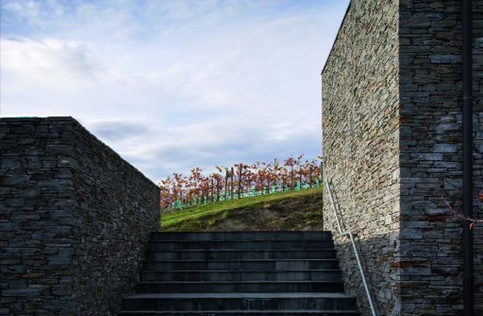 The stairs from the parking area lead down into the sheltered courtyard in the lee of the house.