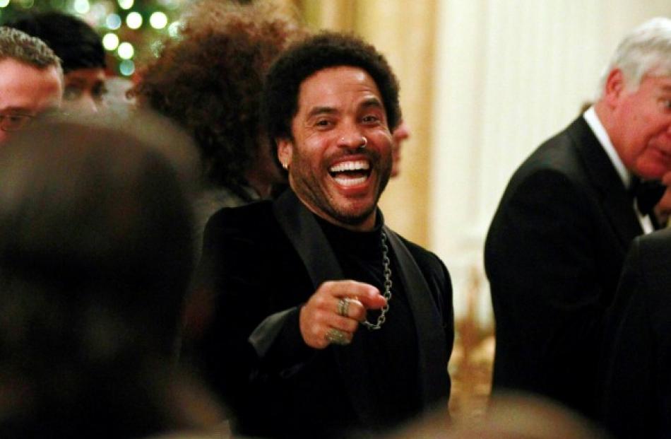 Singer Lenny Kravitz gestures during a ceremony for the 2012 Kennedy Center honorees in the White...