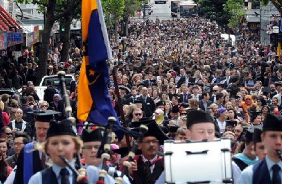 University of Otago graduands parade along George St on Saturday on the way to their graduation...