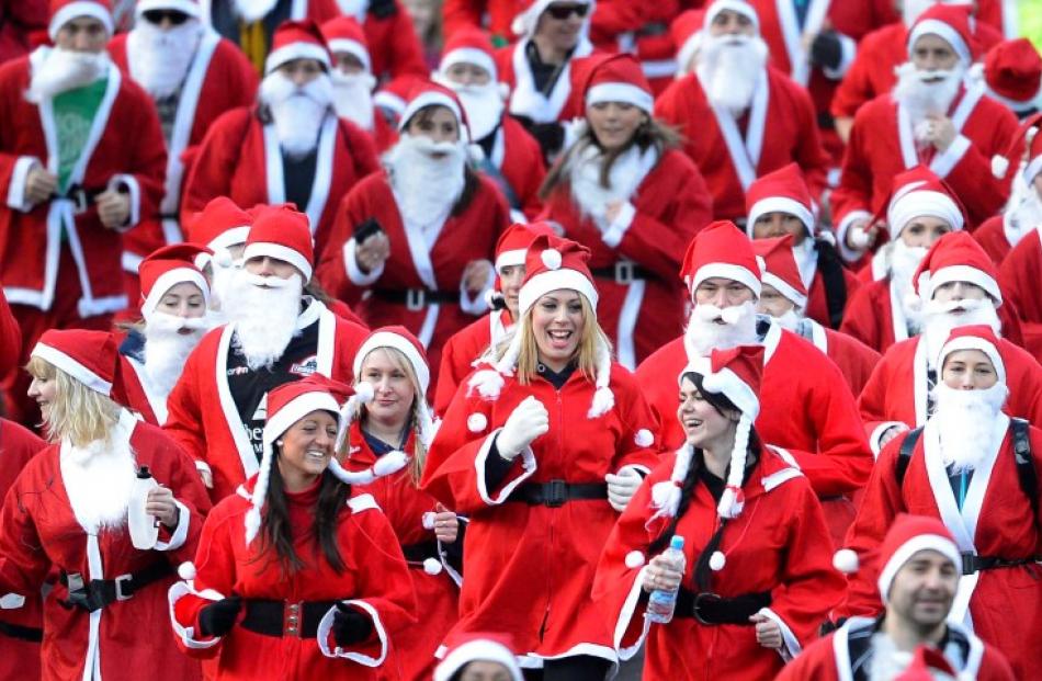 Competitors take part in the annual Great Santa run in the grounds of West Princes Street Gardens...