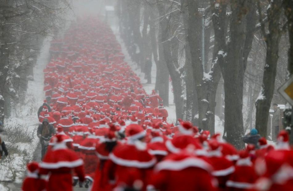 Runners dressed as Father Christmas take part in the so-called 'Nikolaus Run' in the East German...