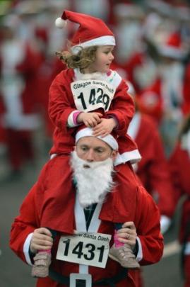 Two people among the 1000 who took part in the annual Santa Dash in Glasgow, Scotland. (Photo by...