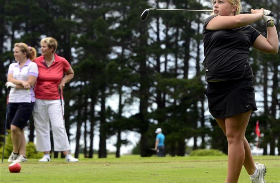 Otago No 1 Laura Hoskin hits off the tee while team-mates Jo Hicks-Beach (left) and Liz McRae...