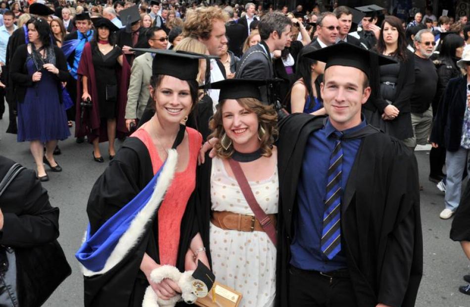 University of Otago graduands Sarah Mockett (21), Adele Price (21) and Victor Komarousky (21)...