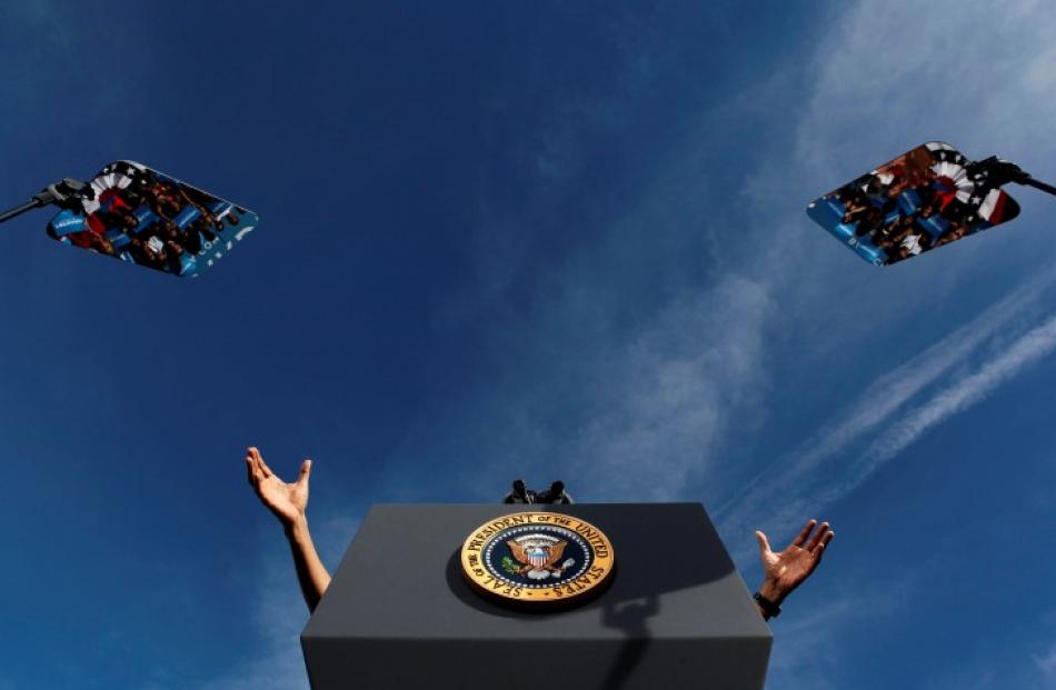 The hands of US President Barack Obama are seen with his teleprompters at a campaign event at...