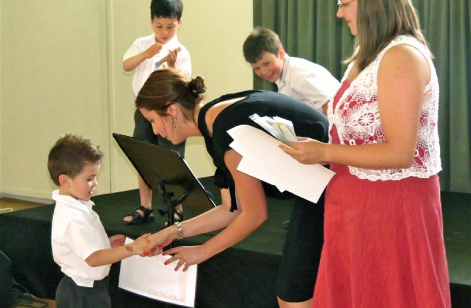 KingsView School pupils (from left) Sam Vining (5), Alexander Poole (5) and Tau Judd (6) accept...