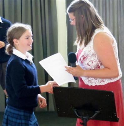 Mackenzie Shewan (10) is congratulated by senior classroom teacher Marlene van Tonder.