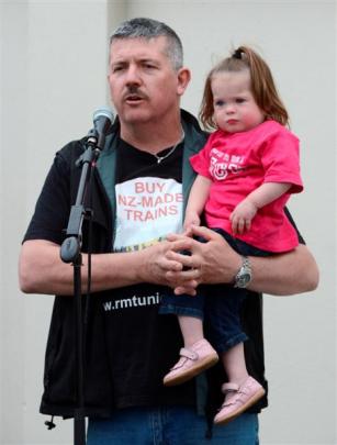 Rail and Maritime Transport Union Hillside branch chairman Stuart Johnstone holds his 2-year-old...