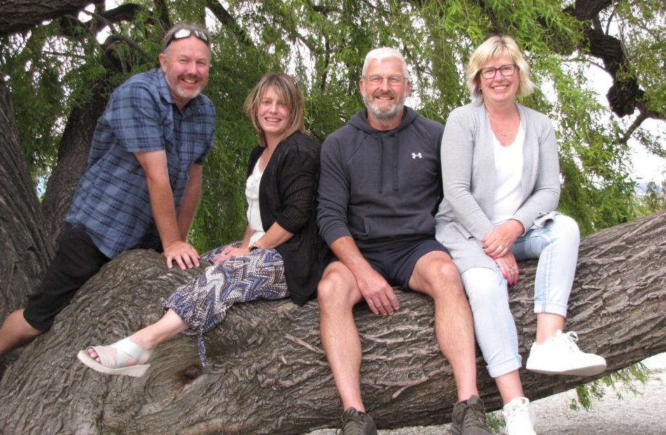 Darryl Gallagher (left), Leah Munro, Jason Hardy and Jennifer Hardy, all of Christchurch, enjoy a seat in willow tree on the lakefront in Wanaka. Photo: Marjorie Cook
