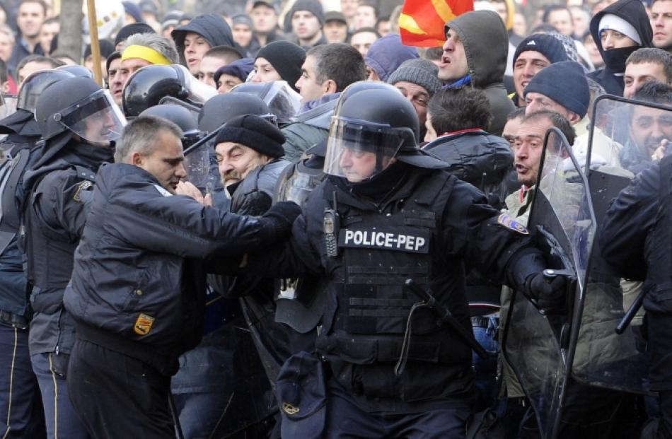 Police confront protestors in front of Macedonia's parliament building in Skopje. Photo by Reuters.