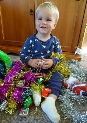 Tyson Sheat (1) puts Christmas tree decorations away at his grandparents’ house near Palmerston...