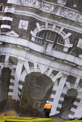 Wind gusts troubled contractors installing the scrim on the front of the Dunedin Railway Station...