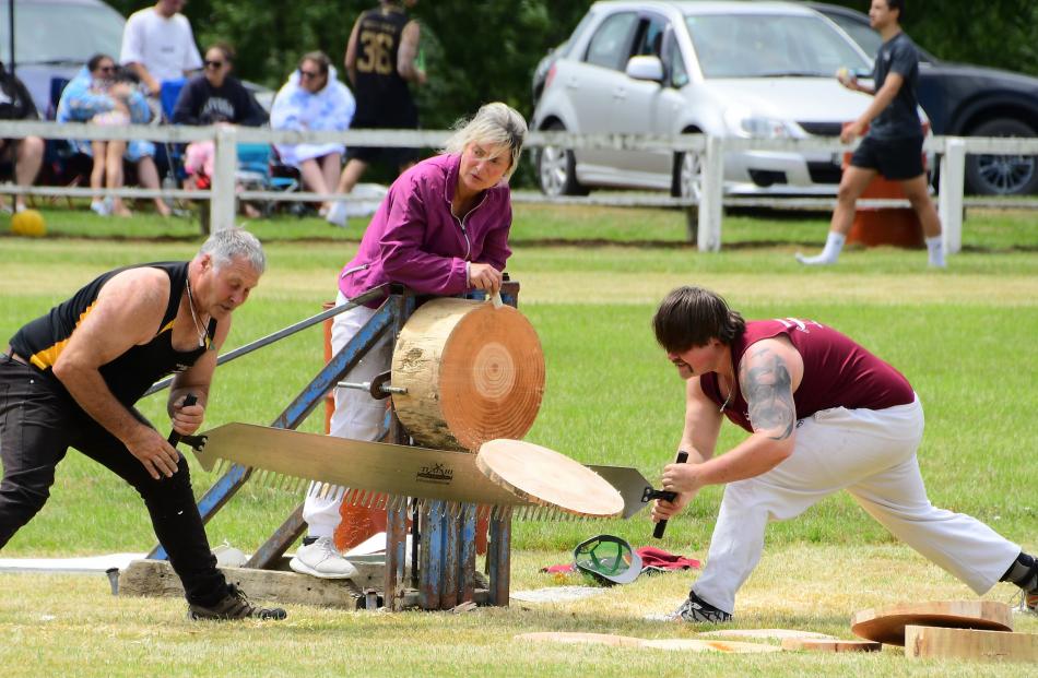 Wayne and Nic Corbin complete the job, assisted by Karen Corbin, in a sawing event at the...