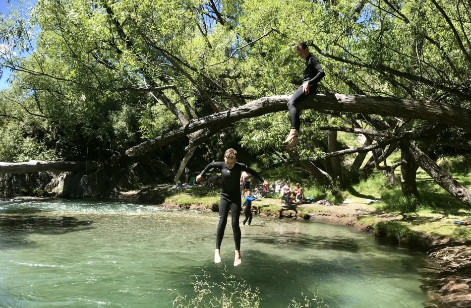 Scott Brown (12) jumps watched by brother Cam (14) at the Arrow River, near Queenstown, on Boxing...