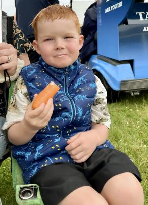 Thomas Flannery (4) enjoys a snack at the Roxburgh races on Tuesday. PHOTO: JACKIE WHITE
