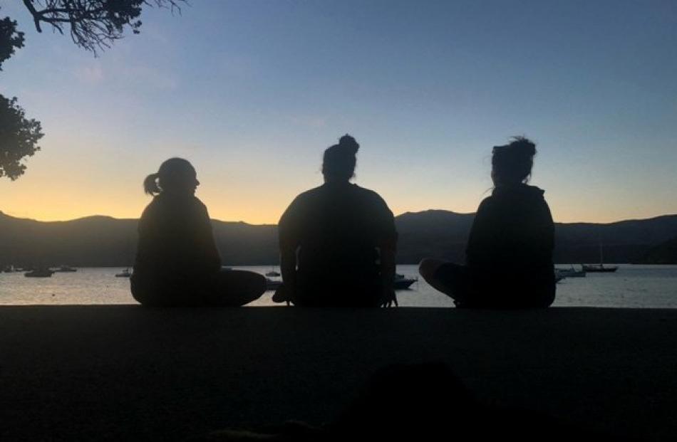 Sisters Waverleigh Pelvin, Tinaka Jopson and Jacinda Kohey in Akaroa at dusk on New Year's Day....