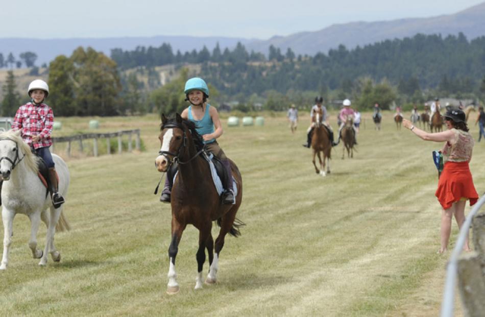 Leading the Junior Trot are Penelope Chapman-Cohen (10) of Tarras (left) and the race winner...