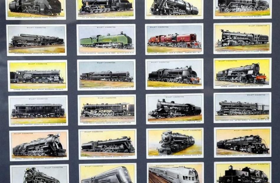 Cards from old cigarette packets, featuring locomotives, are framed to hang on the wall.