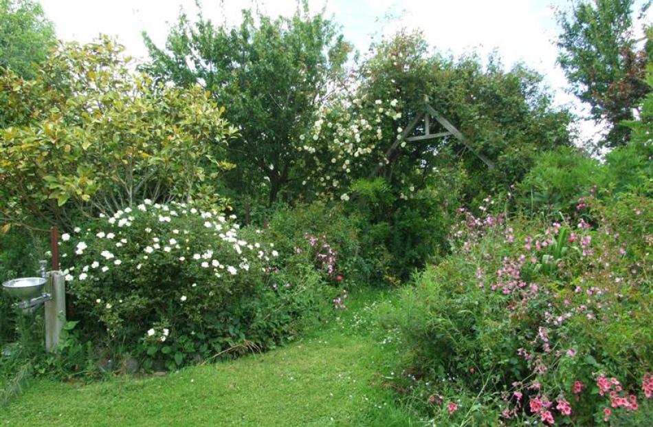 The gardens around the former church are filled with shrubs, trees and flowers.