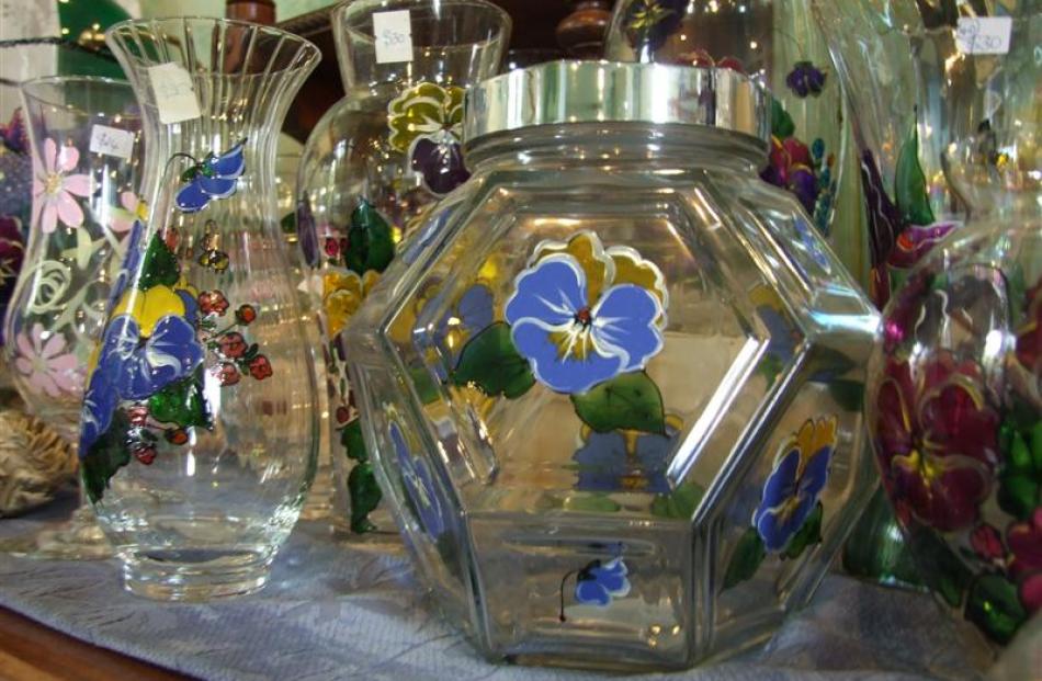 The main area open to the public features Christine's art. Pictured is glassware decorated with...