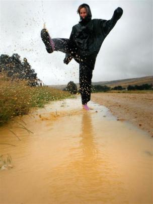 Romy Wales (15) kicks up a puddle on the Knobby Range, near Roxburgh, yesterday. Photo by Tarin...