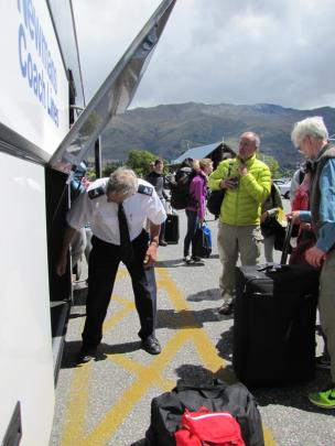 Newmans driver John Hamilton unloads bags at Wanaka after driving a full coach load of passengers...