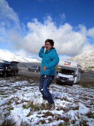 Katrin Einax, of Leipzig, Germany, dodges snowballs in the carpark at the top of the Crown Range,...