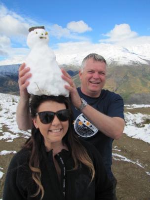 Nigel Crisp, of Perth, fits daughter Hayley with a snowman hat.