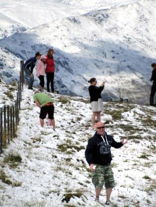 Tourists stop at the top of the Crown Range to play.