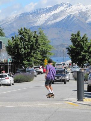 Snow on the mountains as downtown Wanaka is blazing in midsummer sun.