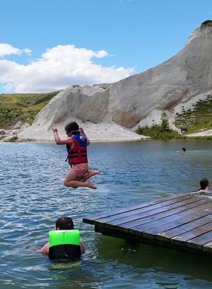 Isabel Armstrong (5) jumps off the jetty at St Bathans’ Blue Lake on Boxing Day, as her brother...