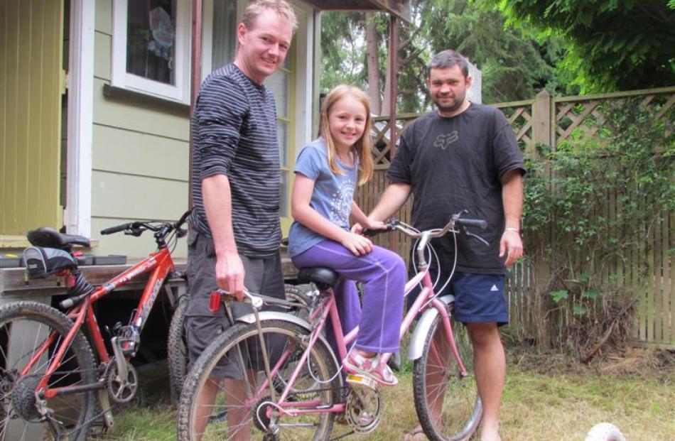 Bryce Saunders (left), Chelsea Saunders (8) and Aaron Hall prepare for a family bike ride at the...