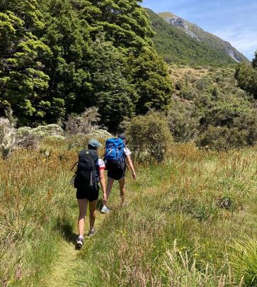 Isla (12, left) and Annabel (15) Ludgate tramp in the Cobb Valley, Kahurangi National Park, on...