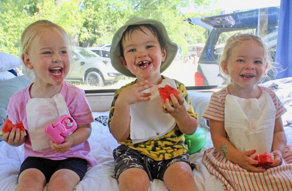 Cousins (from left) Katie Cockburn, Reed Wilson and Georgie Hawker (all 2) enjoy some watermelon...