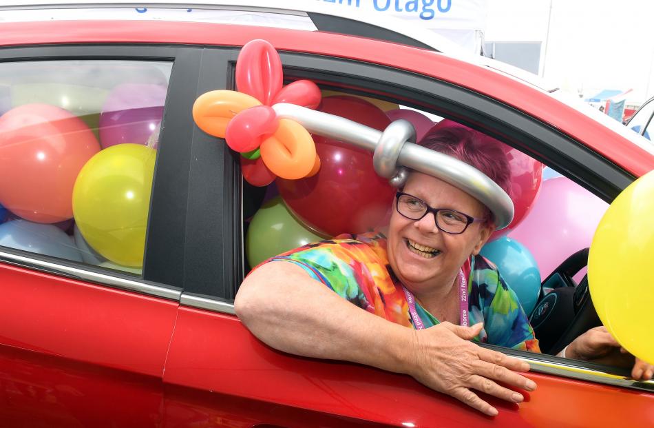 In a car full of balloons for a Scouts fundraiser is Caroline Brok. Money raised is to send...