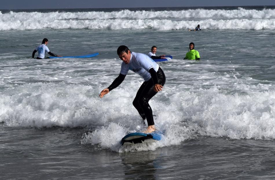 Sheep and beef farmer Chris Kensington, of Palmerston, rides a wave at the January 20 event.