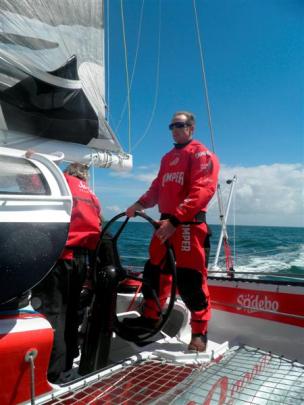 Stu McLachlan takes the helm of Sodebo, a 105-foot racing trimaran, off the coast of Lorient,...